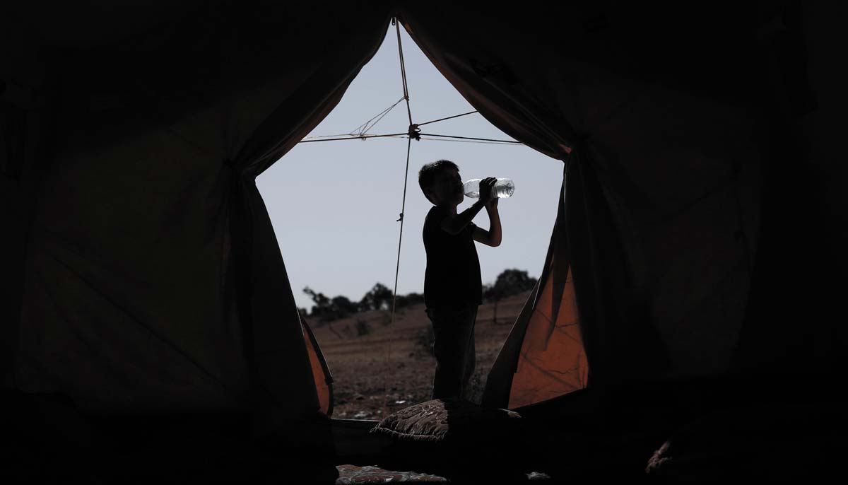 The unbearable conditions of summer weigh heavily on displaced families living in camps in north-west Syria. — OCHA/Abdul Aziz Qitaz