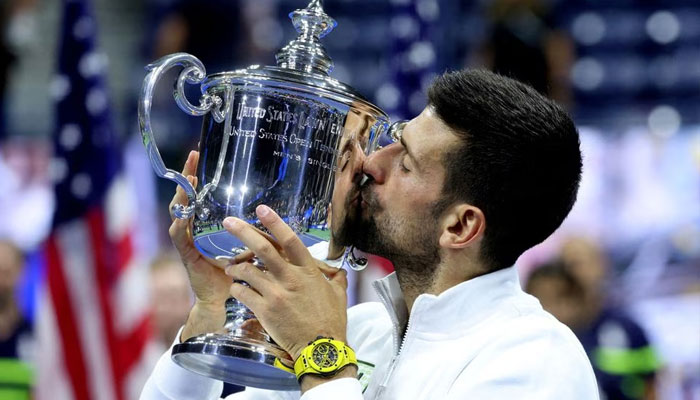 Tennis - US Open - Flushing Meadows, New York, United States - September 10, 2023, Serbias Novak Djokovic celebrates with the trophy after winning the US Open—Reuters