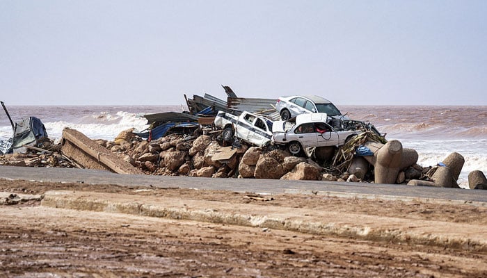 This handout picture provided by the office of Libya´s Benghazi-based interim prime minister on September 11, 2023, shows a view of vehicles piled up along the side of a coastal road in the eastern city of Derna—AFP