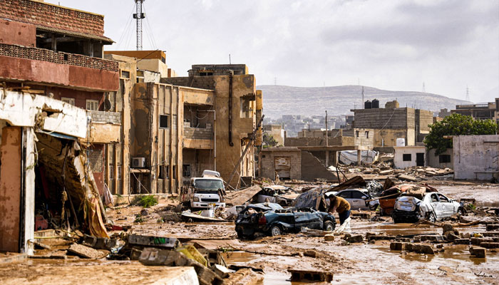 This handout picture provided by the office of Libya´s Benghazi-based interim prime minister on September 11, 2023, shows a view of destroyed vehicles and damaged buildings in the eastern city of Derna.—AFP