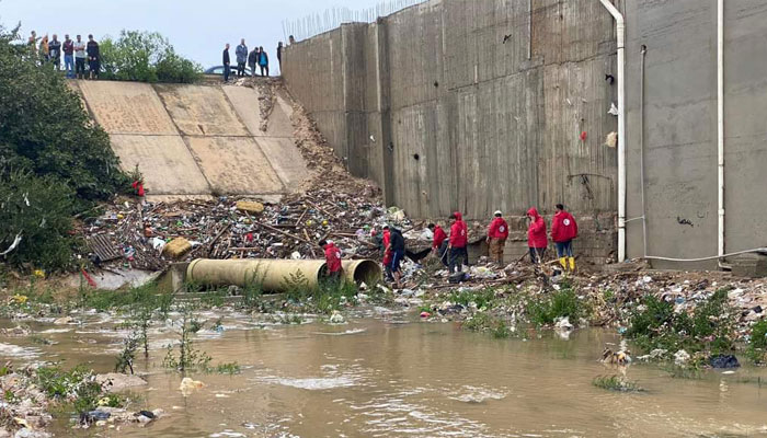 This picture released by the Libyan Red Crescent on September 11, 2023, shows members of their team working on opening roads engulfed in floods at an undefined location in eastern Libya.—AFP