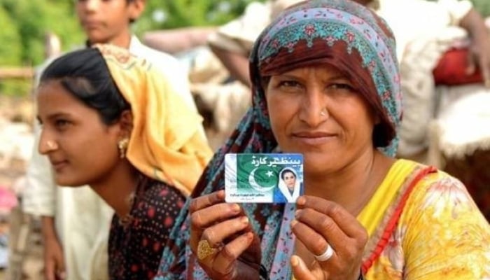 A woman holds up her BISP card in this undated photo. — X/@hiratanvirkaira