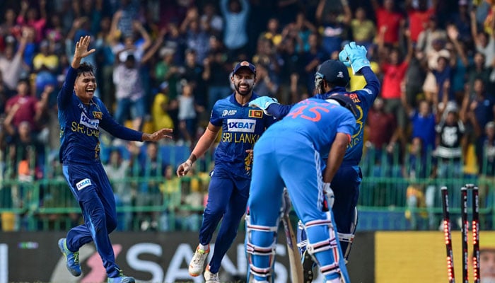 Sri Lanka´s Dunith Wellalage (left) celebrates with teammates after taking the wicket of India´s captain Rohit Sharma (R) during the Asia Cup 2023 Super Four ODI cricket match between India and Sri Lanka at the R. Premadasa Stadium in Colombo on September 12, 2023. — AFP
