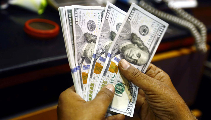 A currency dealer counts US dollar bills at a currency exchange office, in Karachi on Thursday, July 13, 2023. — PPI