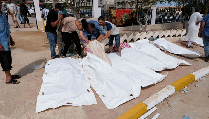 People look at the dead bodies outside the hospital, after a powerful storm and heavy rainfall hit Libya, in Derna, Libya September 12, 2023. —Reuters