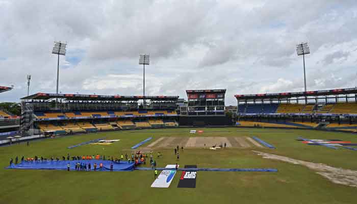 Groundmen prepare covers for the pitch after heavy overnight rains ahead of the third day play of the Asia Cup 2023 super four one-day international (ODI) cricket match between India and Pakistan at the R. Premadasa Stadium in Colombo on September 11, 2023. — AFP