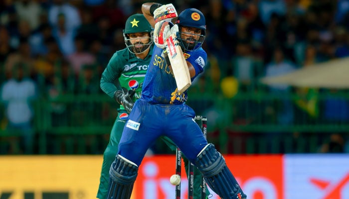 Charith Asalanka plays a shot while Mohammad Rizwan looks on during Pakistan vs Sri Lanka match at the R. Premadasa Stadium in Colombo. — Sri Lanka Cricket