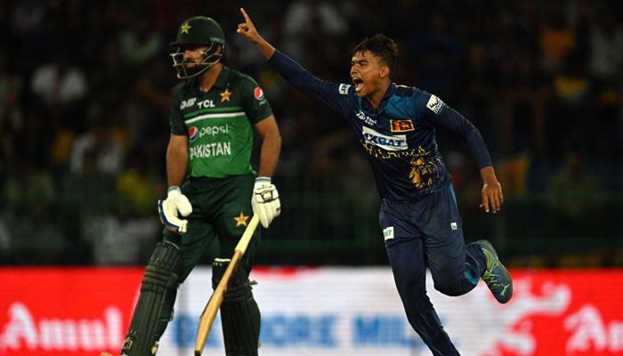 Dunith Wellalage (R) celebrates after taking the wicket of Pakistans captain Babar Azam as Pakistans Abdullah Shafique (L) watches during the Asia Cup 2023 Super Four ODI match between Sri Lanka and Pakistan at the R. Premadasa Stadium in Colombo on September 14, 2023. — AFP