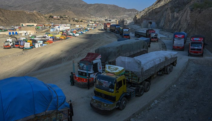 In this picture taken on on September 11, 2023, trucks are seen parked along a road and a parking area near the Pakistan-Afghanistan border in Torkham, after the Torkham border closed on September 6, 2023, following clashes between border forces of both countries. — AFP