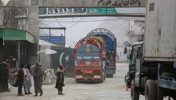 Goods carrier trucks cross into Pakistan at the zero point Torkham border crossing between Afghanistan and Pakistan, in Nangarhar province on February 25, 2023. — AFP
