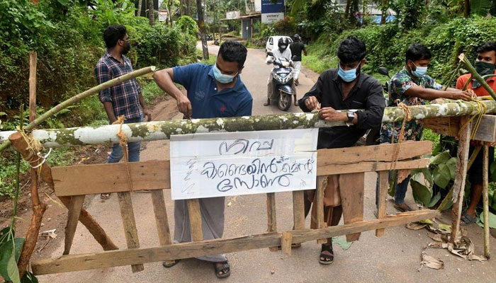 Residents fix a sign reading Nipah containment zone on a barricade, blocking a road after authorities declared it a containment zone in Ayanchery village in Kozhikode district, Kerala, India, September 13, 2023. — Reuters