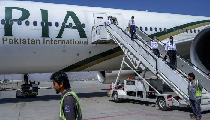 Crew members disembark from a Pakistan International Airlines (PIA) flight at Kabul Airport, Afghanistan, September 13, 2021. — AFP