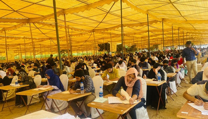 Students appear in MDCAT 2023 tests organised by PMDC in multiple centres across the country. — X/PMDC22