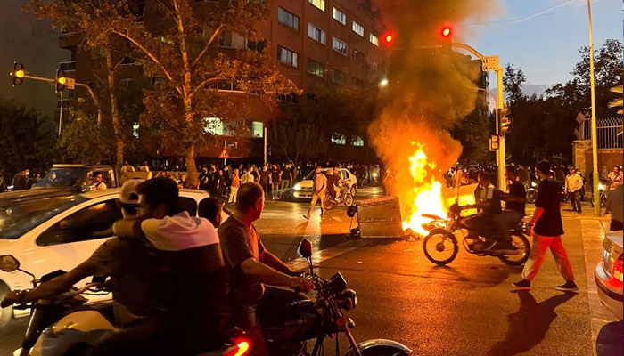 A police motorcycle burns during a protest over the death of Mahsa Amini, a woman who died after being arrested by the Islamic Republics morality police, in Tehran, Iran September 19, 2022. —Reuters