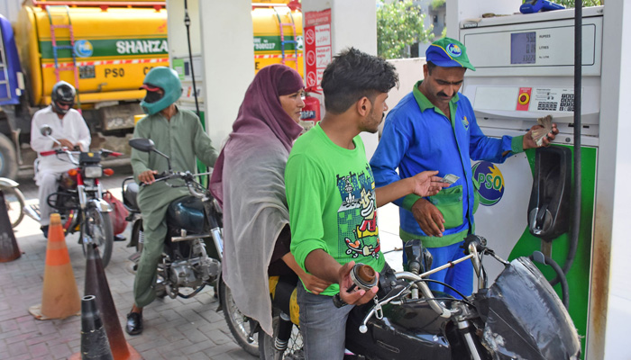 Man gets the tanks of his motorcycle filled amid an unprecedented peak in fuel prices on September 16. 2023. — Online