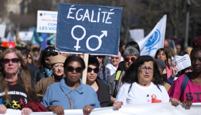 A woman holds a banner reading Equality during an International Women’s Day demonstration in the southern French city of Marseille. — AFP/File