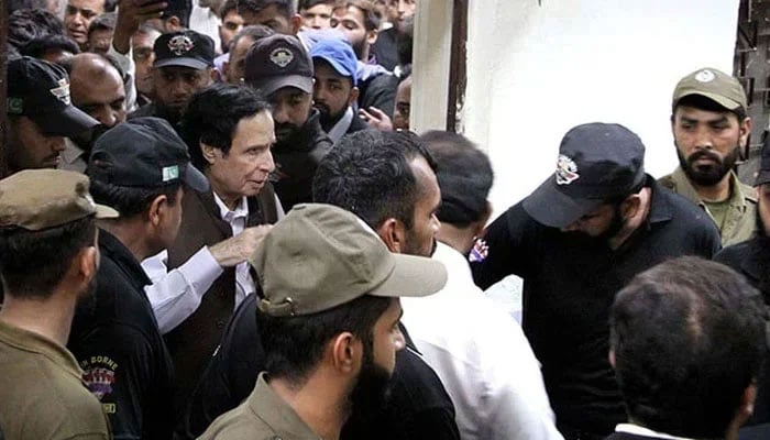 Pakistan Tehreek-e-Insaf (PTI) President Chaudhry Parvez Elahi is being escorted by security officials after a case hearing at a district court in Lahore on Friday, June 2, 2023. — PPI