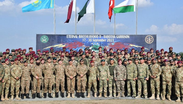 Chief of Army Staff (COAS) General Syed Asim Munir (C) poses for a group photo with the participants of Eternal Brotherhood-II.