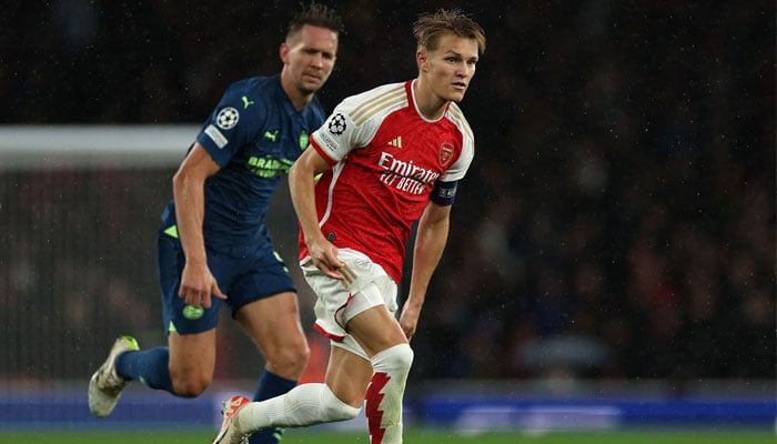 Arsenal´s Norwegian midfielder #08 Martin Odegaard runs with the ball during the UEFA Champions League Group B football match between Arsenal and PSV Eindhoven at the Arsenal Stadium in north London on September 20, 2023. — AFP