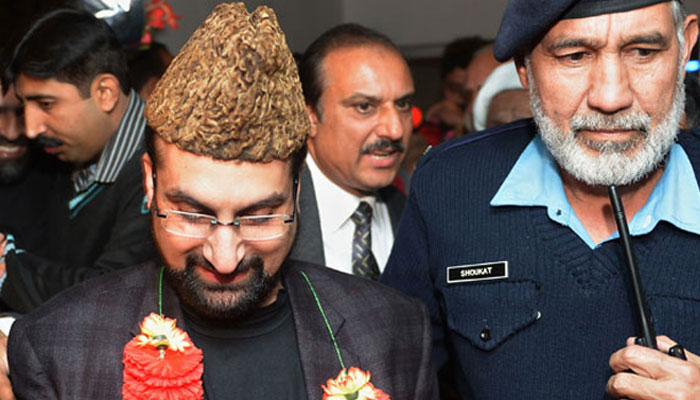 Leader of the moderate All Parties Hurriyat Conference Mirwaiz Umar Farooq (L) comes out from airport upon his arrival in Islamabad on December 15, 2012. - AFP