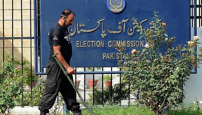 An anti-terrorist force personnel uses a metal detector to scan the area outside the Election Commission of Pakistan in Islamabad on August 26, 2008. — AFP