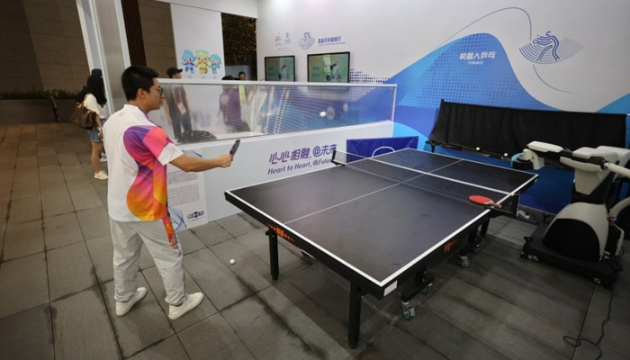 A man plays table tennis with a robot at the Asian Games Village in Hangzhou, Zhejiang province, Sept 12, 2023. — VCG