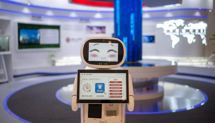 A robot greets visitors at a bank in the Asian Games media centre. — AFP