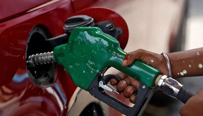 A representational image of a person filling petrol in a car. — Reuters/File