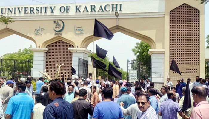 Employees of the University of Karachi are holding a protest demonstration for acceptance of their demand, at the university gate in Karachi on Wednesday, May 3, 2023. — PPI