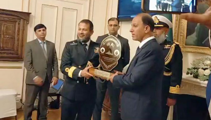 Chief of Naval Staff Admiral Muhammad Amjad Khan Niazi presents a trophy to an officer. — by reporter