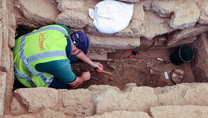 An archaeologist excavates a human skeleton on September 23, 2023, at the site of a cemetery dating from the Roman era, discovered in 2022 in Beit Lahia in the northern Gaza Strip. — AFP/File