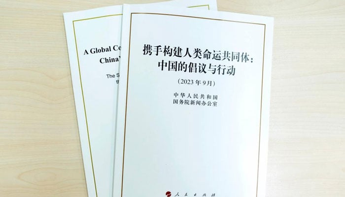 This photo taken on Sept. 26, 2023, shows the Chinese and English versions of a white paper titled A Global Community of Shared Future: Chinas Proposals and Actions.—Xinhua News