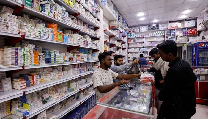 Customers buy medicine from a medical supply store in Karachi, Pakistan February 9, 2023. — Reuters