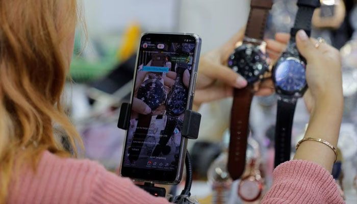 A shopkeeper sells watches live on a social media platform at the International Trade Center (ITC) mall in Jakarta, Indonesia, September 27, 2023. — Reuters