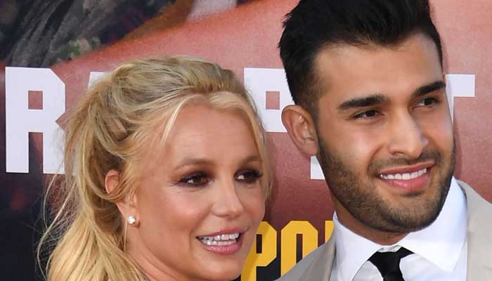 Sam Asghari picks up gun as Britney Spears shows knives in video