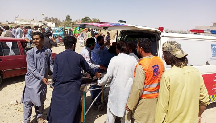 People standing around an ambulance after a blast through Mastung, on September 29, 2023. — Reporter