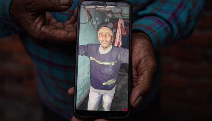 A photo of 26-year-old Isar Muhammed, a Muslim Indian, is displayed on a phone screen. — X/@meerfaisal01