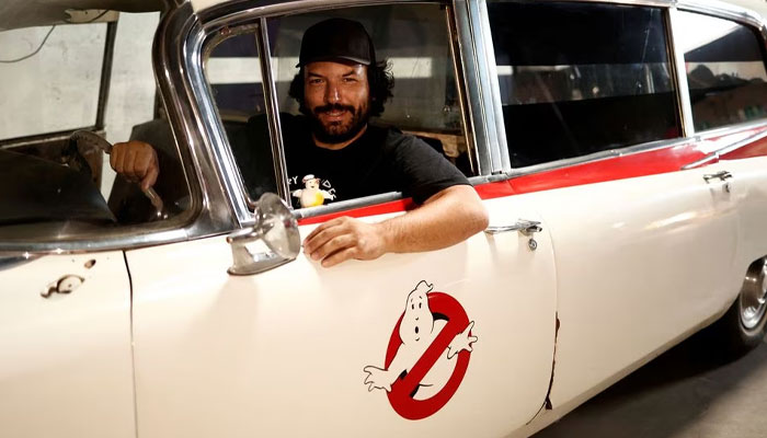 French car collector Franck Galiegue poses in a replica car of the Ghostbusters movie, inside the Pop Central Museum dedicated to legendary vehicles and car replicas from the world of cinema and television in Etrechy, near Paris, France, September 17, 2023. — Reuters