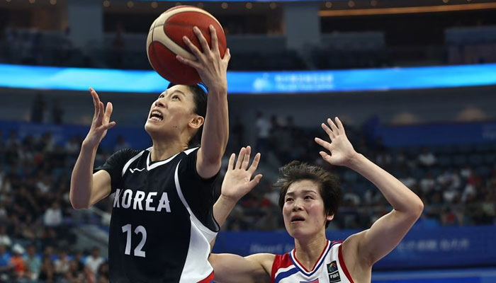 South Koreas Haeran Lee in action with North Koreas Ryona Hong during a basketball match at the Asian Games at Hangzhou Olympic Sports Centre Gymnasium, Hangzhou, China on September 29, 2023 — Reuters