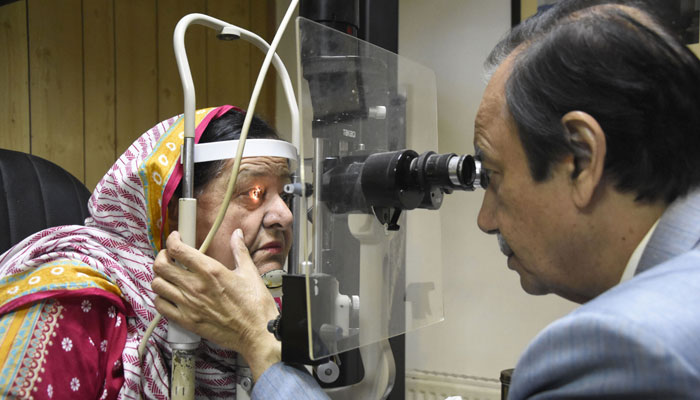 A doctor examines a woman suffering from an eye infection at a hospital in the city as more than 56,000 schools shut for the rest of the week in a bid to curb a mass outbreak of a contagious eye virus. — Online