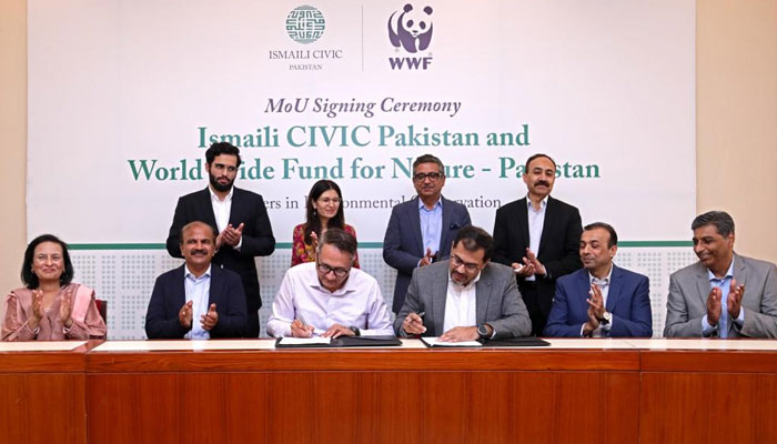 Representatives of Ismaili CIVIC Pakistan and World Wide Fund for Nature - Pakistan are signing the MoU to combat climate change and promote environmental conservation in Karachi.