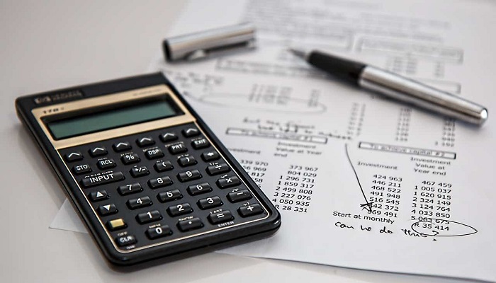 A representational image shows a balance sheet, a pen, and a calculator.—Reuters/File