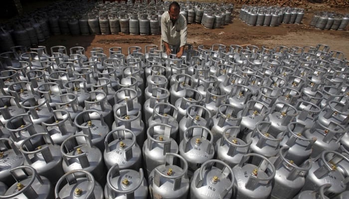 A man can be seen arranging LPG cylinders in this undated image. — Reuters