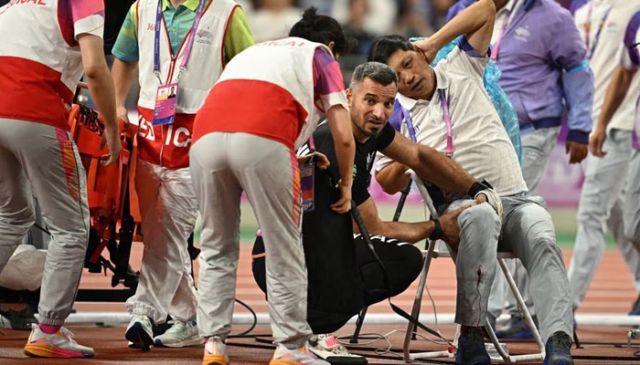 A judge is injured after Kuwaits Ali Zankawi throws the hammer through the net during the Mens Hammer Throw Final at the Asian Games in Olympic Sports Centre Stadium, Hangzhou, China on September 30, 2023. — Reuters