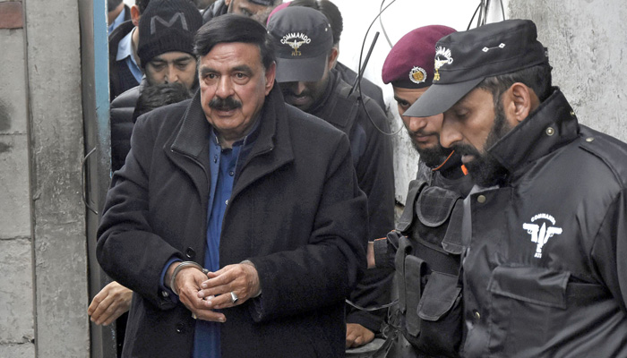 Police officials escort AML Chief Shiekh Rashid, as he arrives to attend a hearing at the additional and sessions court in Islamabad on February 2, 2023. — Online