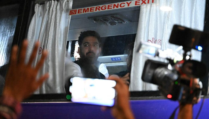 Haris Rauf looks out from a bus carrying Pakistans cricket team upon arriving at Rajiv Gandhi International Airport in Hyderabad, India on September 27, 2023, ahead of the start of the ICC Mens Cricket World Cup 2023. — AFP