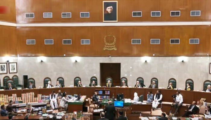 CJP Qazi Faez Isa (centre) heads afull court bench hearingpetitions challenging the law seeking to curtail CJPs discretionary powers at the Supreme Court in Islamabad, on October 3, in this still taken from a video. — YouTube/PTVNewsLive