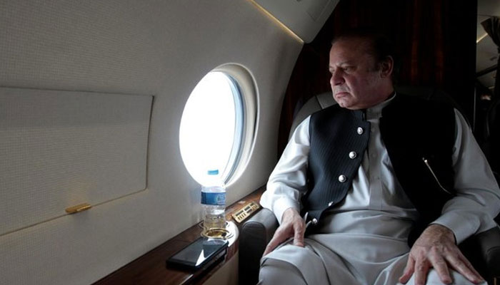 Former Prime Minister Nawaz Sharif looks out the window of his plane after attending a ceremony to inaugurate the M9 motorway between Karachi and Hyderabad, Pakistan on Feb. 3, 2017. — Reuters