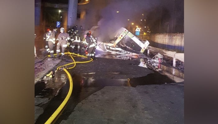 This picture released on October 4, 2023, shows a damaged bus that suffered a crash in Venice after falling off a bridge. — X/@__NorthX