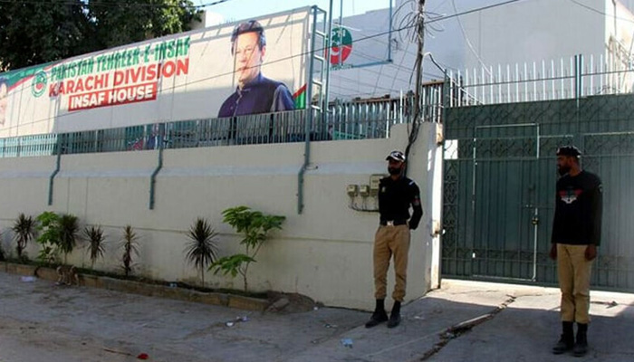 Policemen stand guard outside the PTIs Insaf House in this file photo. — PTI/Facebook